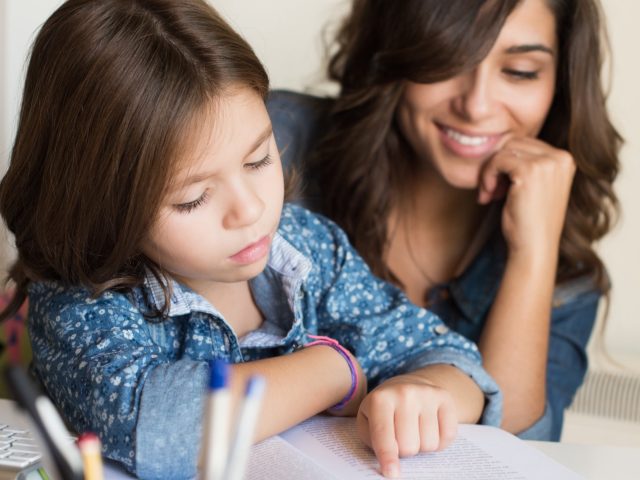 http://Parents%20and%20Students.%20A%20mother%20watches%20as%20her%20daughter%20reads%20a%20book.